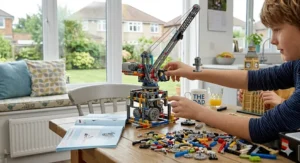 A close-up, photorealistic view of the complex mechanical gears, motors, and piston assembly from an intricate engineering construction crane kit designed for 10 year olds, resting on a wooden table.