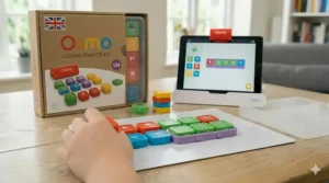 A child monitoring their progress on the Osmo Coding companion app while building a block sequence.