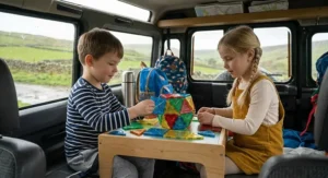 A child in the back of a classic vehicle playing with a small, complex geometric structure made from magnetic building blocks, showcasing travel portability.