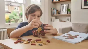 Child following instructions to connect bricks while building a LEGO Marvel playset.