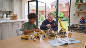 LEGO City heavy-duty construction excavator digger and mobile crane working on a building site.