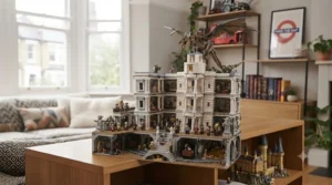 A close-up of the LEGO Harry Potter Icons Collectors' Edition (76391) set. The brick-built Hedwig the owl, with wings spread, is perched on a stack of magical artefacts, including Harry’s glasses, wand, a potions set, and a buildable Hogwarts acceptance letter. The set is displayed on a polished oak surface in a cosy living room, with a soft-focus background of books and plants.