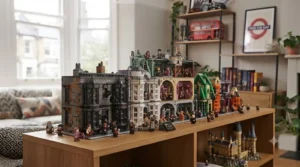 A bespoke, wall-mounted wooden display cabinet filled with a comprehensive collection of LEGO Harry Potter minifigures. The figures are arranged neatly in rows, showcasing dozens of characters from across the films, including various versions of Harry, Ron, Hermione, and numerous professors and magical creatures. The cabinet is LED-lit, making the detailed printing on the minifigures stand out against the blurred living room background.