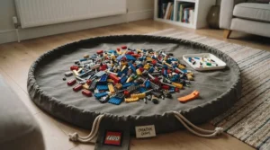 A round canvas play mat with a drawstring closure holding a pile of multicoloured LEGO pieces in a living room.