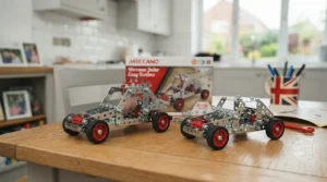 Side-by-side comparison of a metal Meccano beginner set and a plastic construction toy on a neutral background.