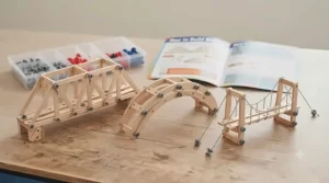 Infographic guide included in the bridge building STEM kit for kids showing arch, beam, and suspension designs.